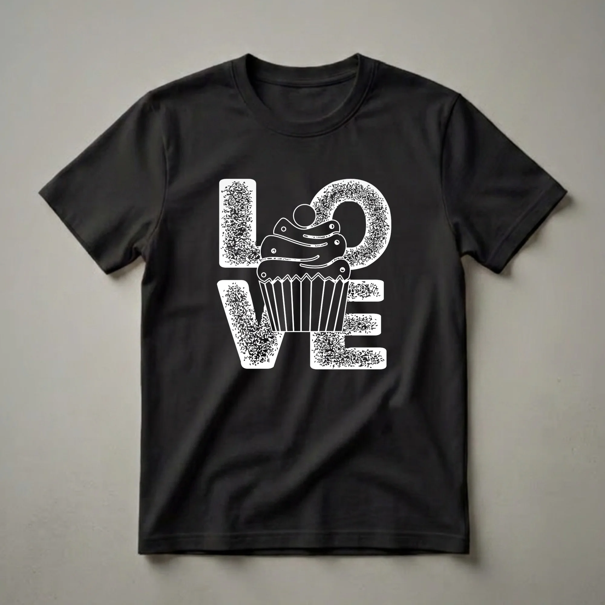 White graphic t-shirt featuring the word LOVE with a cupcake replacing the letter O. The letters have a distressed texture, and the cupcake has frosting and a cherry.