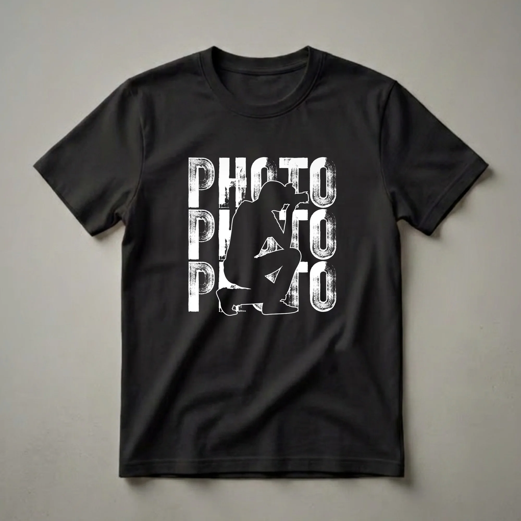 Black t-shirt with a white graphic design of the word PHOTO repeated vertically, with a silhouette of a photographer crouching in the center.