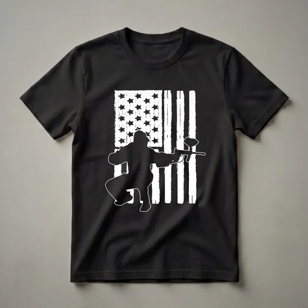 Black silhouette of a paintball player aiming a marker against a distressed American flag graphic, on a black t-shirt.