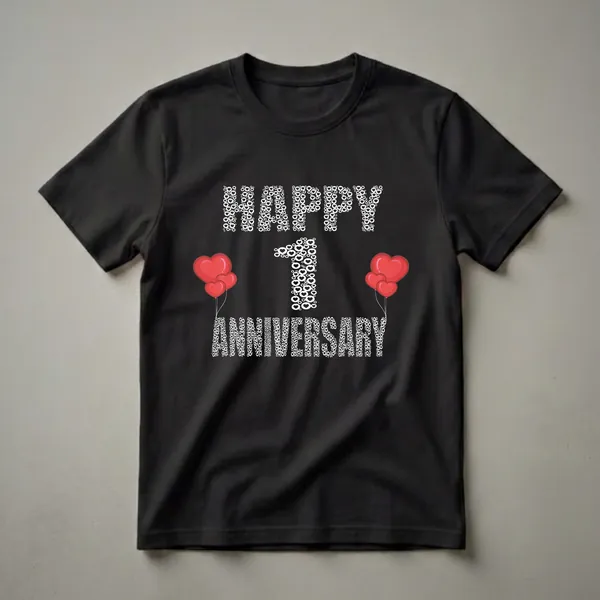 Black t-shirt with white text art spelling 'HAPPY 1 ANNIVERSARY' using hearts and circles, with a large white '1' and red heart balloons on the sides.