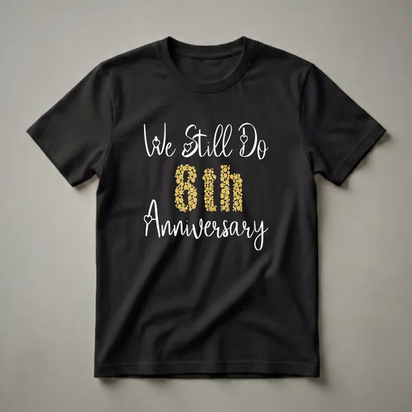 Black t-shirt with white script reading 'We Still Do' and 'Anniversary', with the number '8th' in the center filled with gold circles.