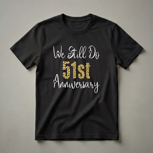 Black t-shirt with white script text 'We Still Do' and 'Anniversary', and gold bubble-filled numbers '51ST' in the center, celebrating a 51st wedding anniversary.