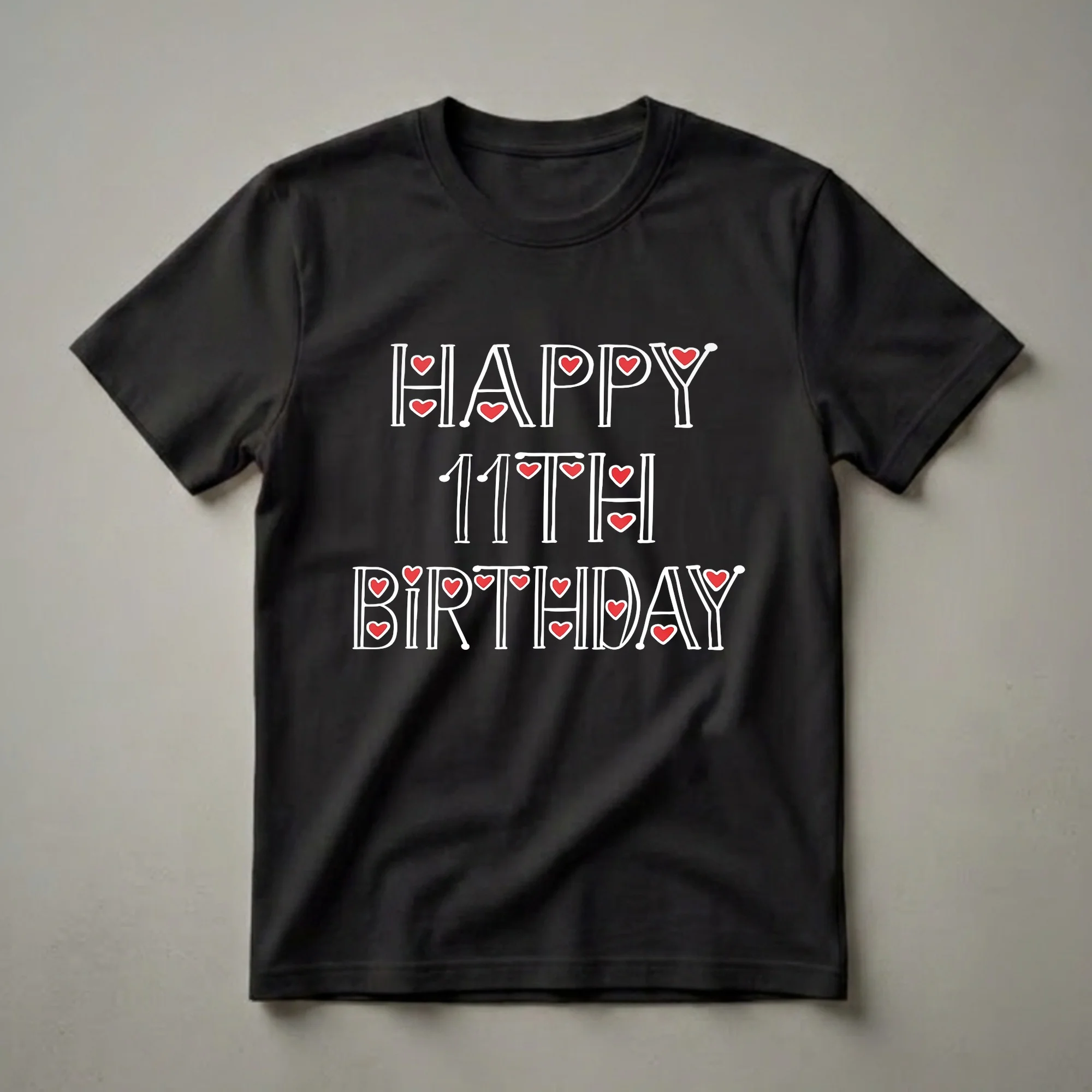 Black t-shirt with white text that reads 'HAPPY 11TH BIRTHDAY' decorated with red hearts.
