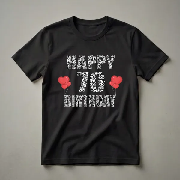 Black t-shirt with white text art that reads 'Happy 70th Birthday' composed of hearts and circles, with red heart balloons on the left and right sides.