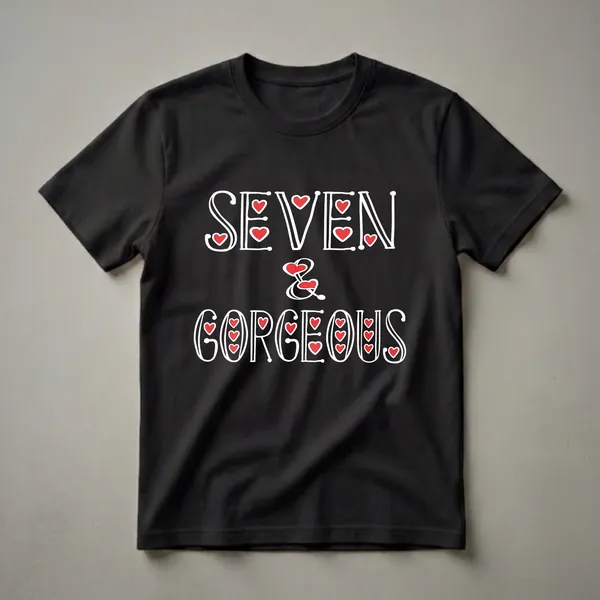 Black t-shirt with white text that reads 'SEVEN & GORGEOUS' with red heart accents, celebrating a 7th birthday.
