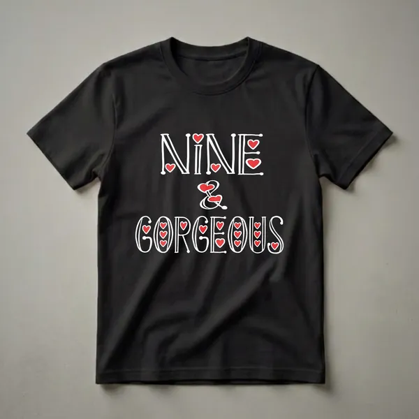 Black t-shirt with white text that reads 'NINE & GORGEOUS' in a decorative font, with red heart accents throughout the design.