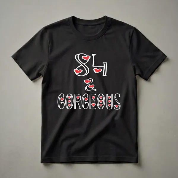Black t-shirt with white text that reads '84 & Gorgeous' with red heart accents.