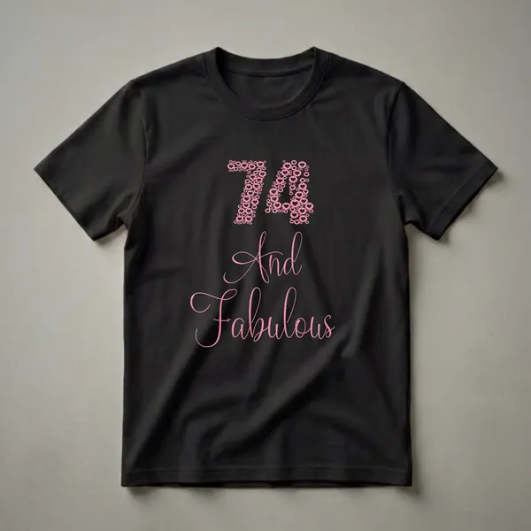 A black t-shirt featuring the number 74 made of pink glittery hearts and circles, with the words 'And Fabulous' below in a matching pink glittery cursive font.
