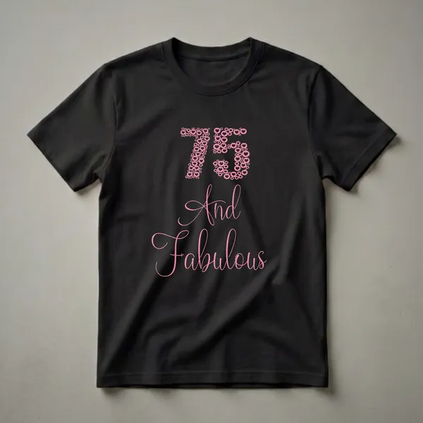 Black t-shirt featuring the number 75 and the words 'And Fabulous' in a glittery pink font, composed of hearts and circles.
