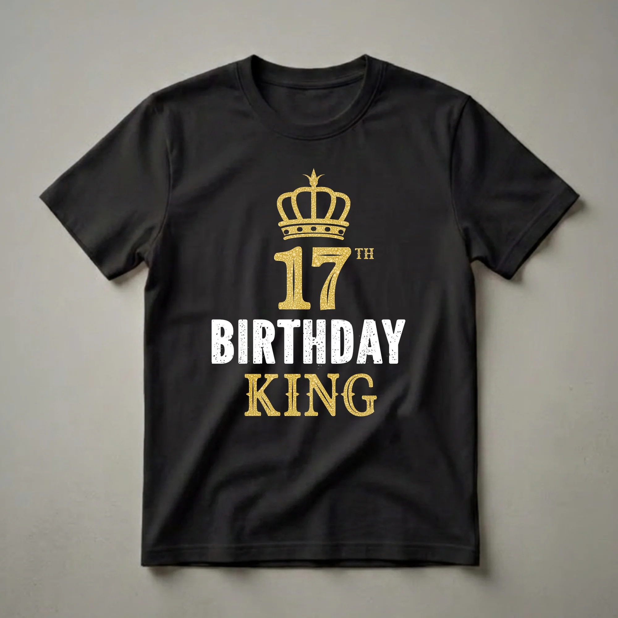 Black t-shirt with a gold crown graphic above the number 17 and the words BIRTHDAY KING in distressed white and gold lettering.