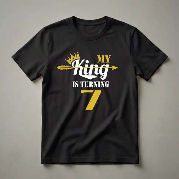 Black t-shirt with white and gold text that reads 'MY King IS TURNING 7', featuring a gold crown and a gold arrow.