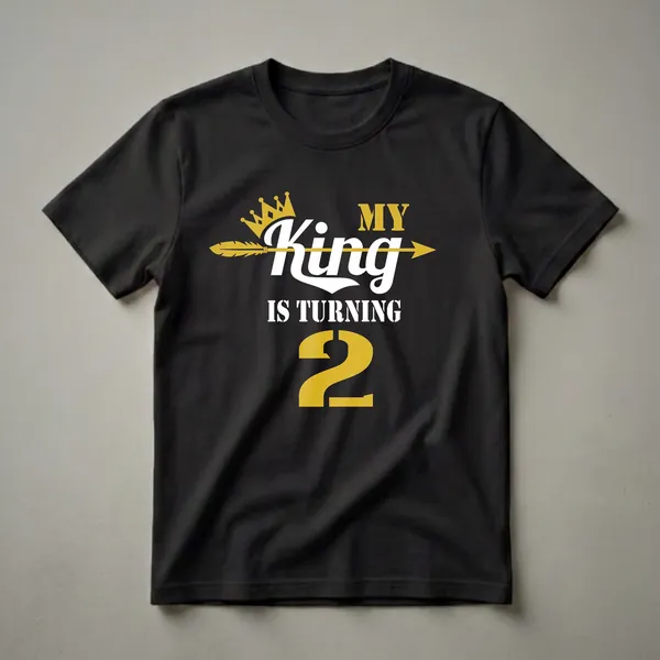 Black t-shirt with gold and white text that reads 'MY King IS TURNING 2', featuring a gold crown and a gold arrow.