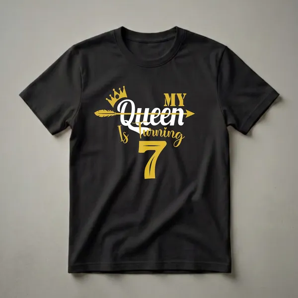 Black t-shirt with gold and white text that reads 'My Queen Is Turning 7' with a gold crown and arrow graphic.