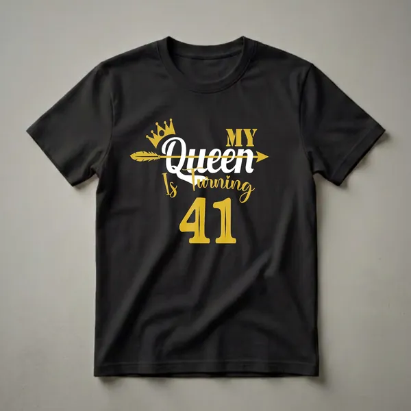 Black t-shirt with gold and white text that reads 'My Queen Is Turning 41' with a crown and arrow graphic.