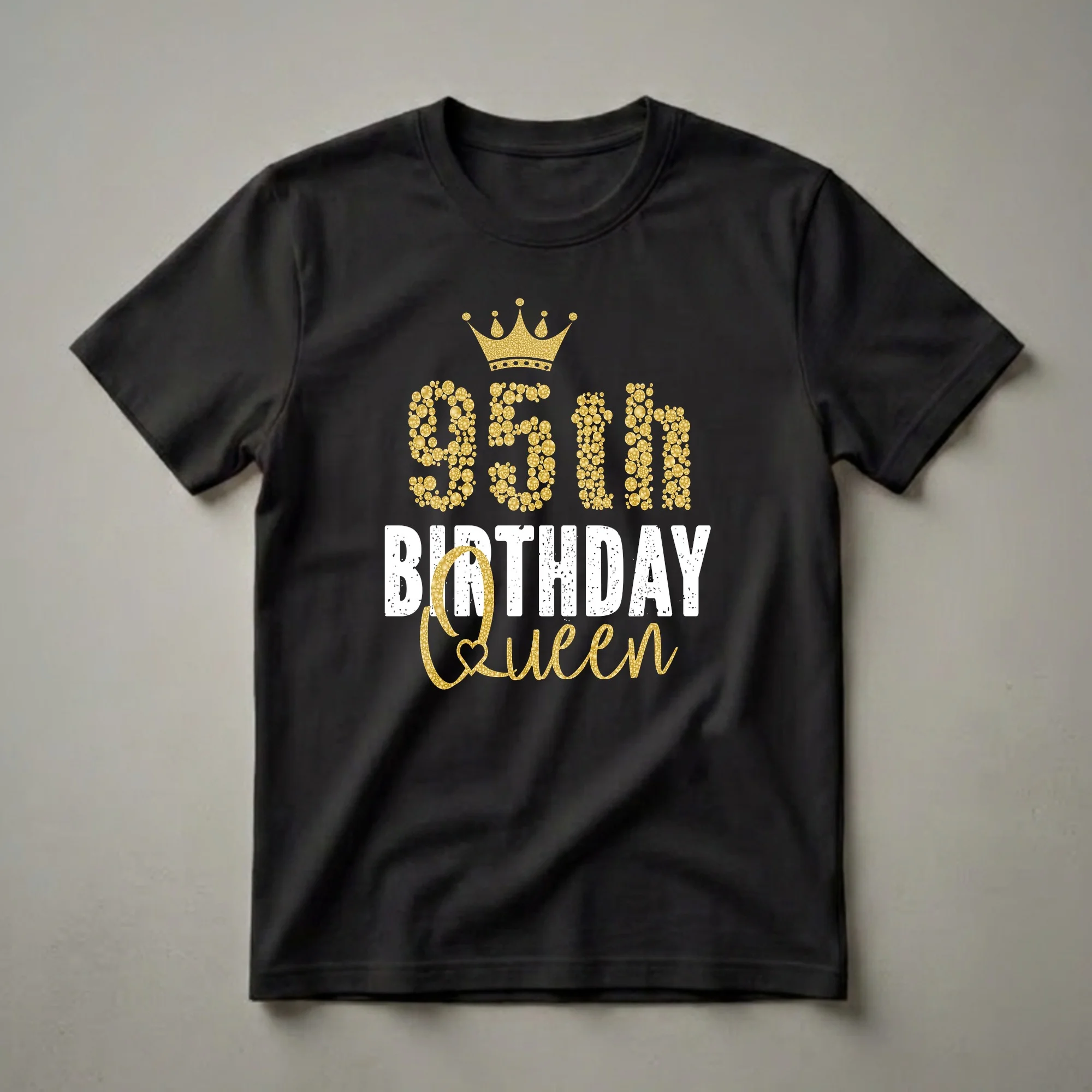 Black t-shirt with gold bubbly numbers and script that reads '95th Birthday Queen' and a golden crown graphic.