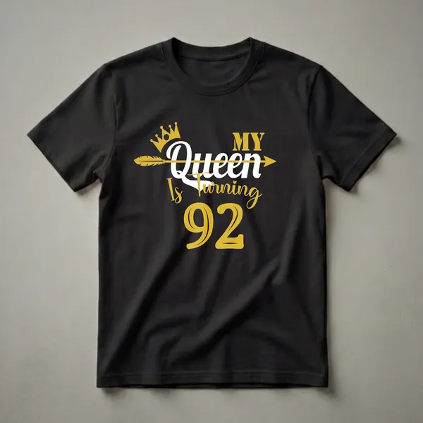 Black t-shirt with gold and white text that reads 'My Queen Is Turning 92' with a crown and arrow graphic.