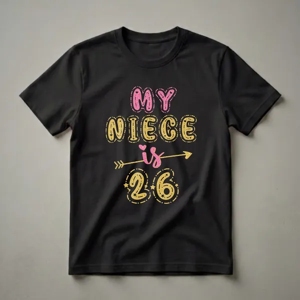 Black graphic t-shirt with glittery pink and gold text that reads 'MY NIECE is 26', adorned with hearts, stars, and an arrow.