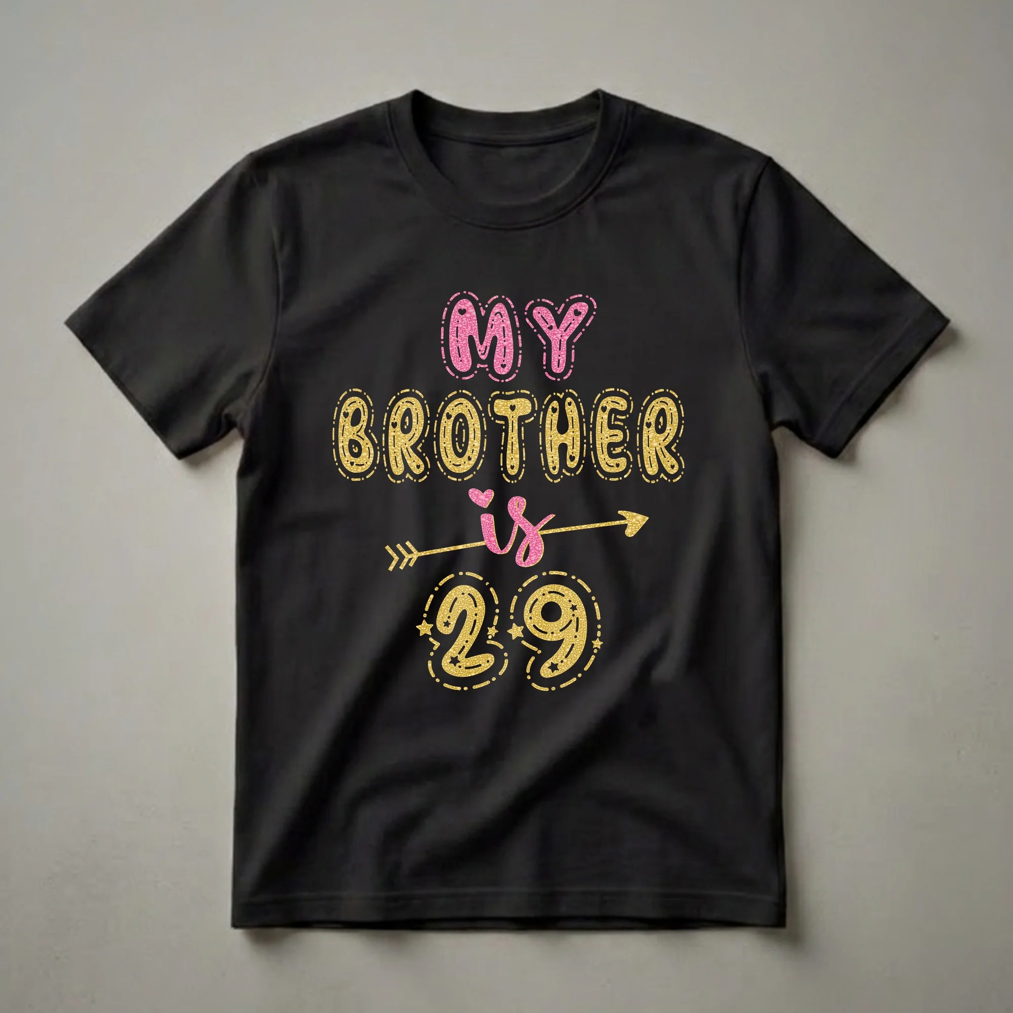 Black t-shirt with glittery pink and gold text that reads 'MY BROTHER is 29', with decorative stars and an arrow graphic.