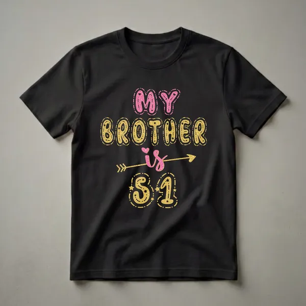 Black t-shirt with pink and gold glitter-effect text that reads 'MY BROTHER is 51' with decorative elements like an arrow and stars.