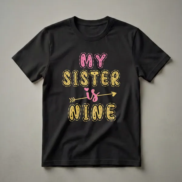 Black t-shirt with glittery gold and pink text that reads 'MY SISTER IS NINE', featuring an arrow through the word 'IS'.