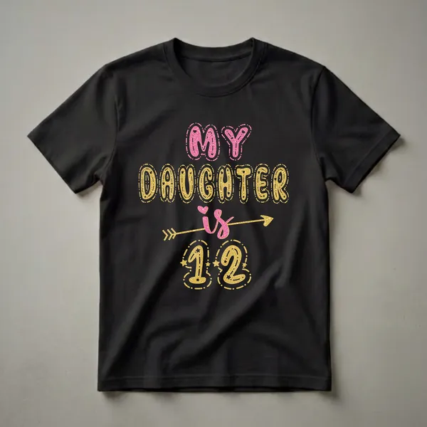 Black t-shirt with the text 'MY DAUGHTER is 12' in pink and gold glitter effect, featuring decorative arrows and stars.