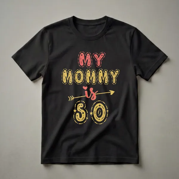 Black t-shirt with the text 'MY MOMMY' in red glitter and 'is 50' in gold glitter, with decorative arrows and stars.