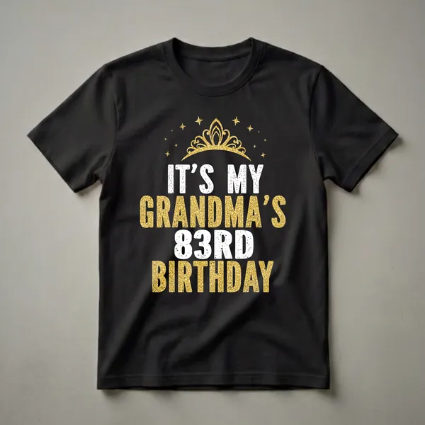 Black t-shirt with white text 'IT'S MY GRANDMA'S' and gold glitter text 'GRANDMA'S 83RD BIRTHDAY' with a gold crown and stars above.
