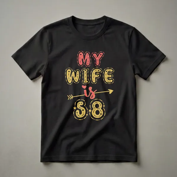 Black t-shirt with red and gold glitter text that reads 'MY WIFE is 58', with an arrow and festive accents.
