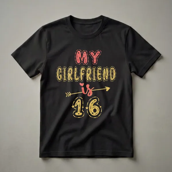 Black t-shirt with the text "MY GIRLFRIEND IS 16" in glittery red and gold fonts, adorned with hearts, stars, and an arrow.