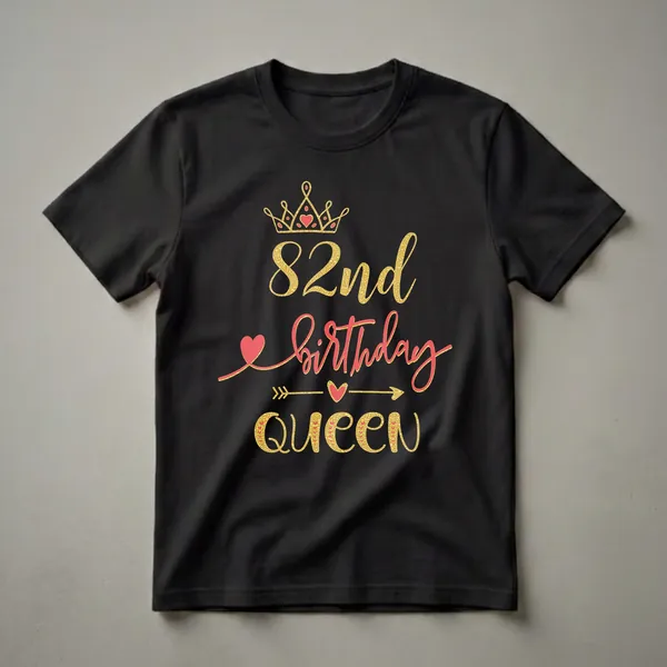 Black t-shirt featuring a golden crown with red hearts, the text '82nd birthday Queen' in gold and red script and block letters, and decorative arrows and hearts.
