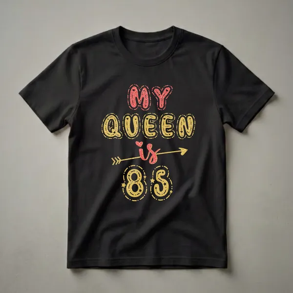 Black t-shirt with the text 'MY QUEEN is 85' in glittery red and gold fonts, with an arrow and decorative elements.