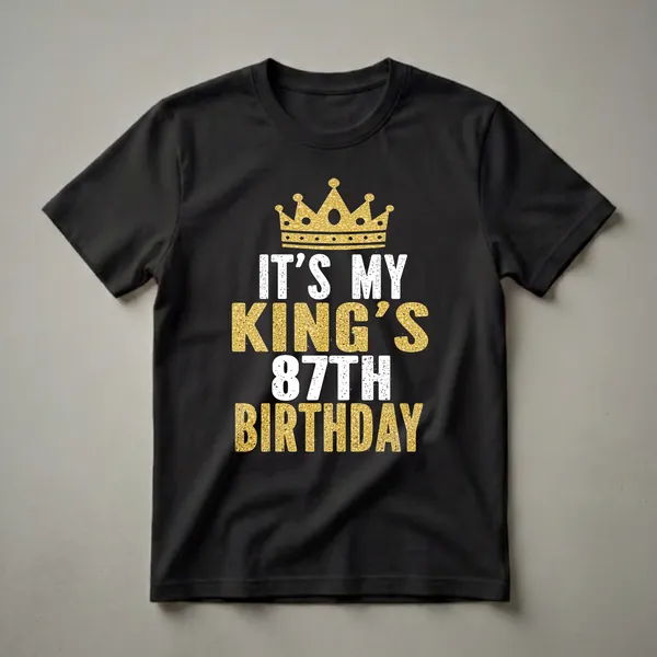 Black t-shirt with a gold crown graphic and white and gold text that reads 'IT'S MY KING'S 87TH BIRTHDAY'.