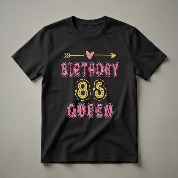 Black t-shirt with 'BIRTHDAY 85 QUEEN' text graphic in pink and gold glittery fonts, featuring a golden arrow and pink heart.