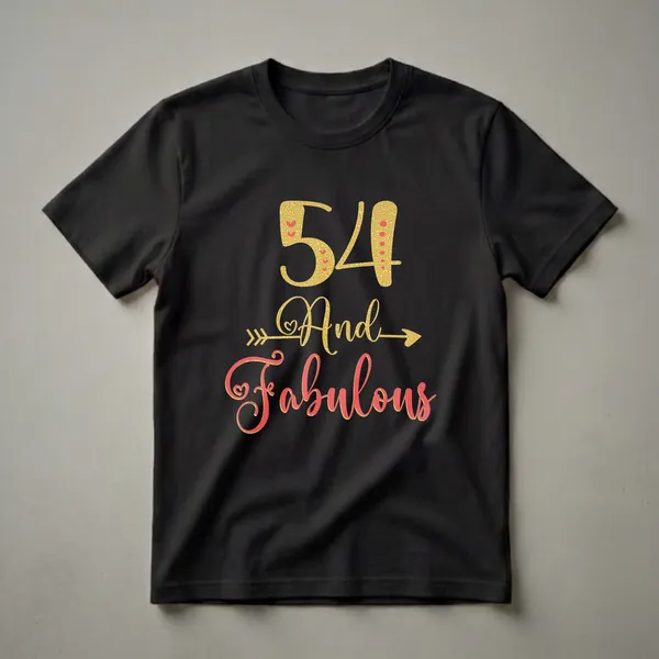 Black t-shirt with gold and coral text that reads "54 And Fabulous" with decorative hearts and an arrow graphic.