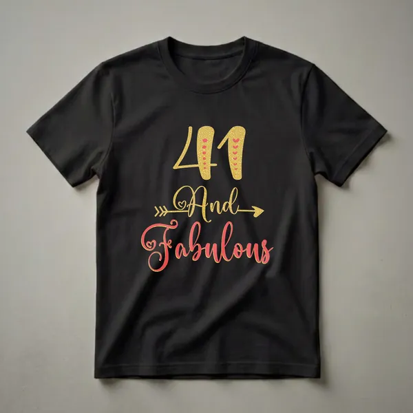Black t-shirt with gold glitter '41' and coral script 'And Fabulous' with decorative accents.