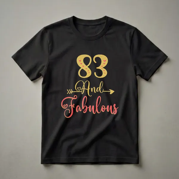 Black t-shirt with gold glitter '83' and coral script 'And Fabulous' with gold glitter outline and heart accents.