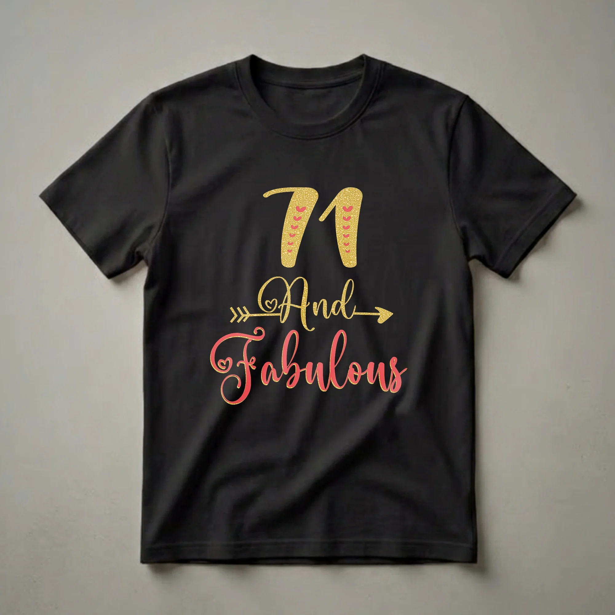 Black t-shirt with gold glitter '71' and red hearts, followed by 'And Fabulous' in gold and coral red glitter script with decorative arrows and hearts.