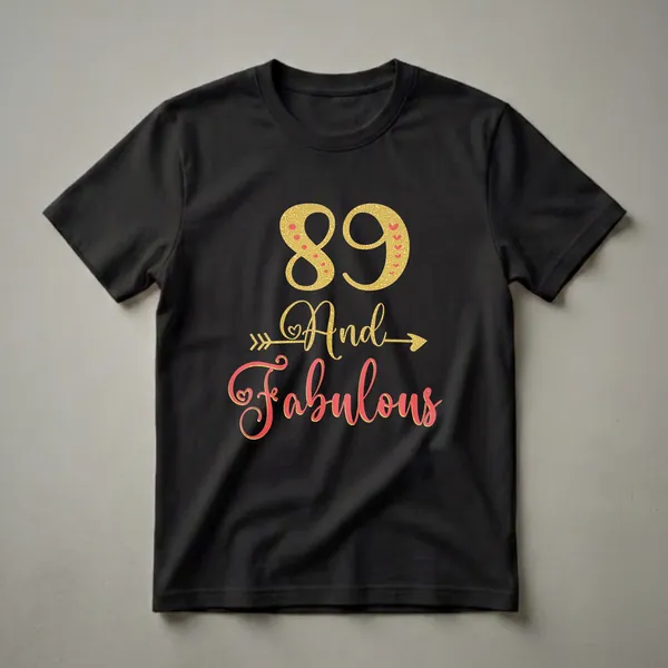 Black t-shirt with gold glitter '89' and coral script 'And Fabulous' with arrow accents, celebrating an 89th birthday.