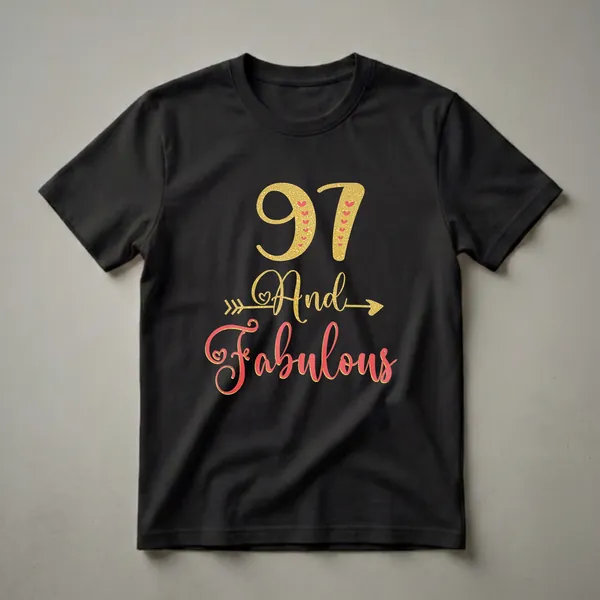 Black t-shirt with '97' in gold glitter and coral hearts, 'And' in gold glitter with an arrow, and 'Fabulous' in coral glitter with gold trim.