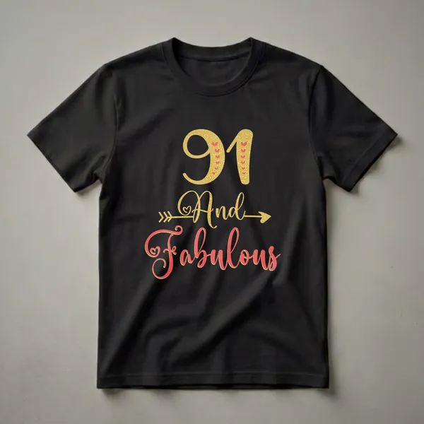 Black t-shirt with gold glitter '91' and coral script 'And Fabulous', accented with red hearts and a gold arrow, for a woman's 91st birthday.