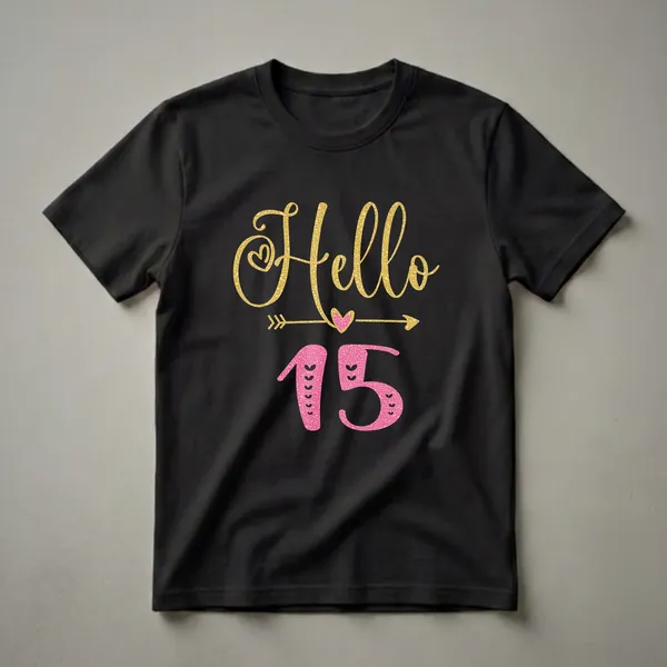Black t-shirt with 'Hello' in gold glitter script and '15' in pink glitter, featuring hearts and an arrow graphic.