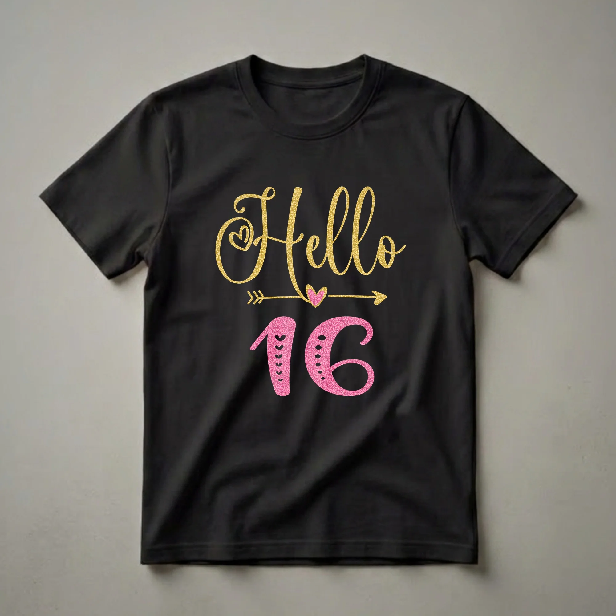 Black t-shirt featuring the text 'Hello' in gold glitter and '16' in pink glitter, with decorative hearts and arrows.