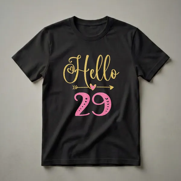 Black t-shirt with gold glitter 'Hello' and pink textured '29' with hearts and arrows, celebrating a 29th birthday.