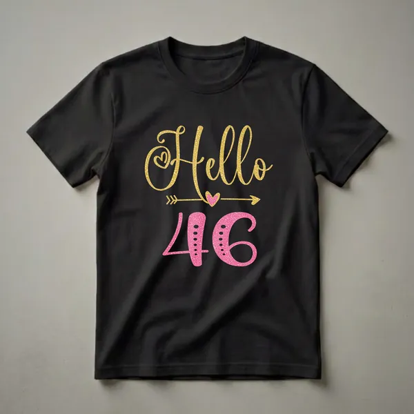 Black t-shirt featuring the text 'Hello' in gold glitter and '46' in pink glitter, with decorative hearts and arrows.