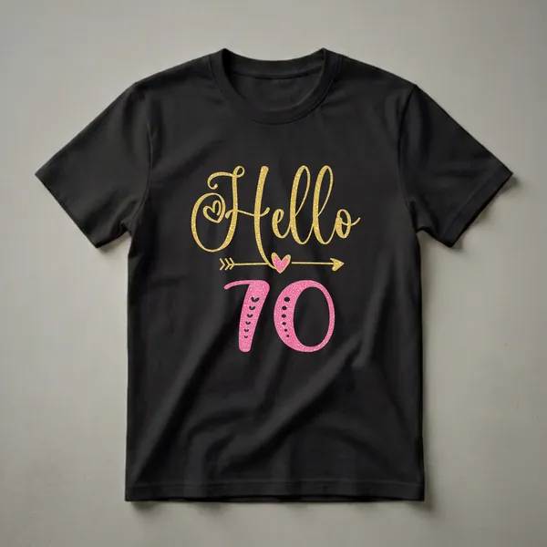 Black t-shirt with gold script 'Hello' and pink textured '70' with decorative hearts and arrows.