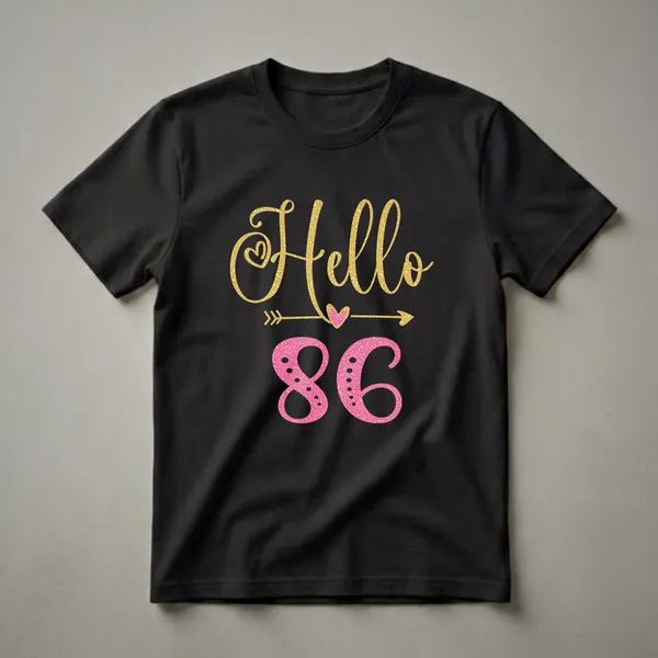Black t-shirt with gold glitter 'Hello' and pink glitter '86' with hearts and arrows graphic.