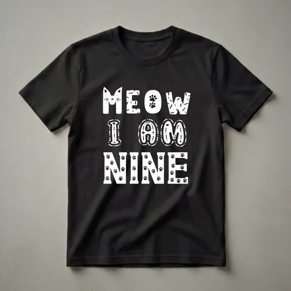 White 'Meow I Am Nine' text with cat face and paw print graphics on a black t-shirt, celebrating a 9th birthday for a cat lover.