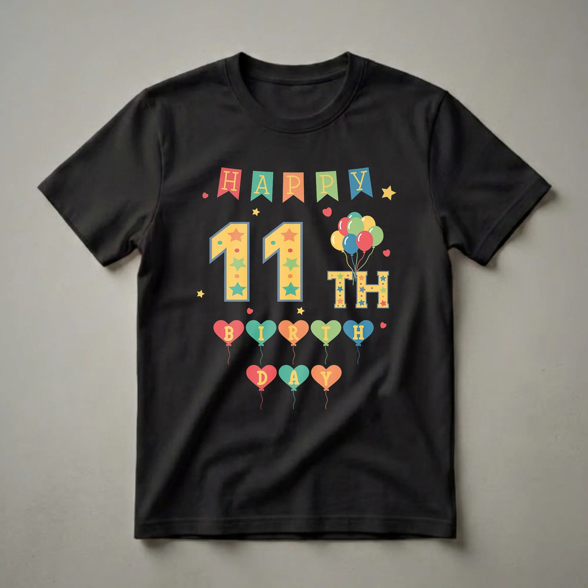 A black t-shirt featuring a colorful 'Happy 11th Birthday' graphic with banners, stars, balloons, and the number 11.
