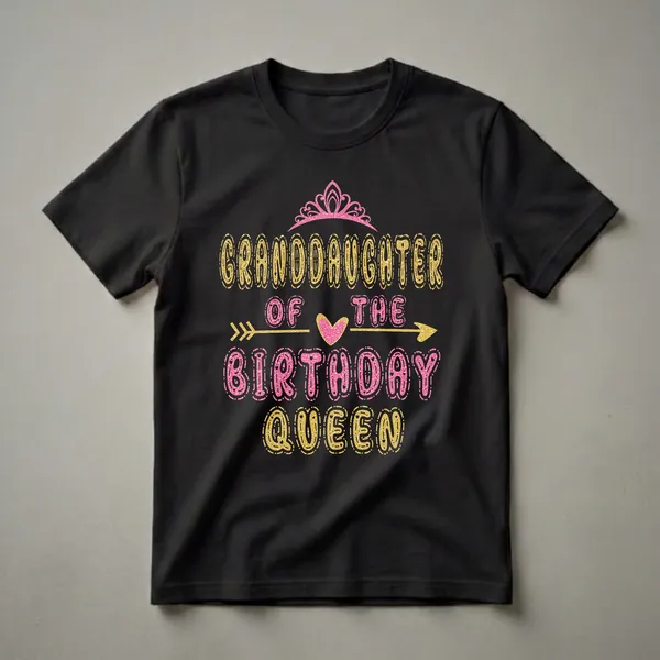 Black t-shirt with 'Granddaughter of the Birthday Queen' text in glittery gold and pink fonts, a pink crown, and a gold arrow.