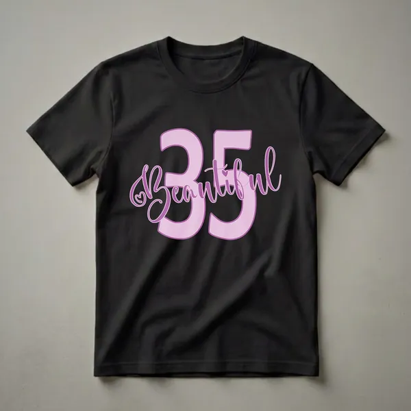 Light pink graphic t-shirt with purple outline featuring the number 35 and the word Beautiful in script font, with a small heart detail.